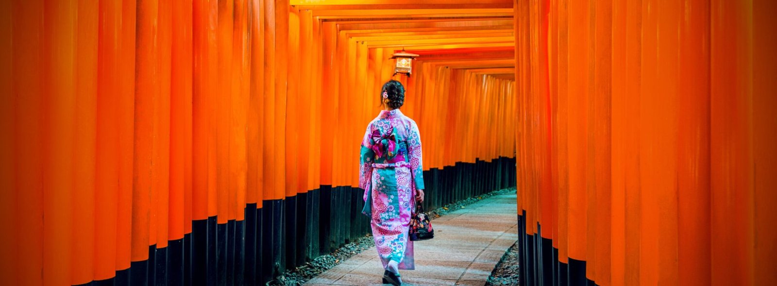 Asian women in traditional japanese kimonos at Fushimi Inari Shrine in Kyoto, Japan.
